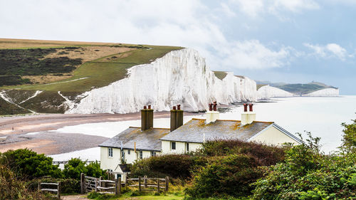 Panoramic view of buildings and sea against sky