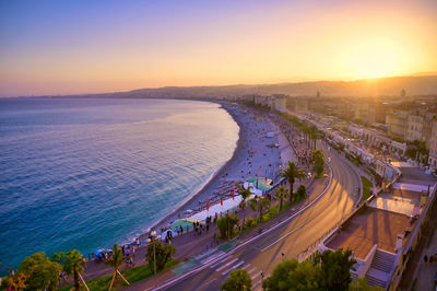 High angle view of road by sea against sky during sunset