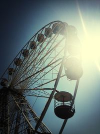 Low angle view of ferris wheel against sky
