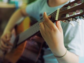 Midsection of person playing guitar