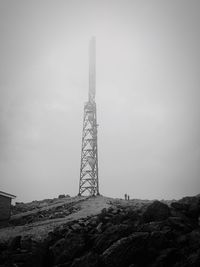 Low angle view of communications tower against sky