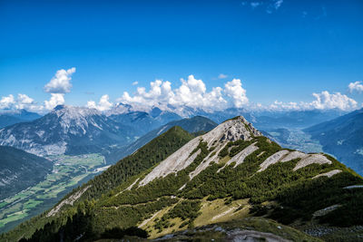 Scenic view of snowcapped mountains against blue sky