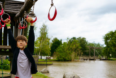 Climbing boy on the playground outside in center parc in niederlande