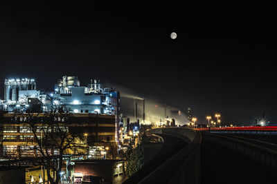 Illuminated city against sky at night