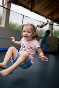 Cheerful girl enjoying on trampoline