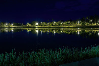 Scenic view of lake against sky at night