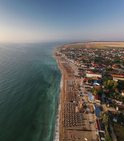 High angle view of sea and cityscape against sky