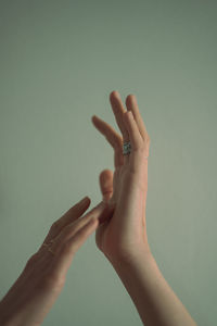 Cropped image of hand against wall