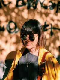 Portrait of woman wearing sunglasses while standing outdoors