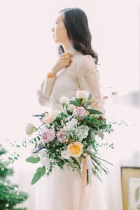 Close-up of woman holding bouquet of flower