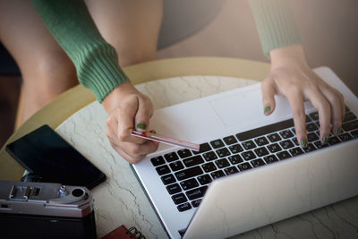 Midsection of woman using mobile phone