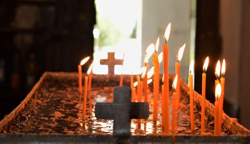 Close-up of lit candles in temple