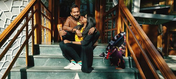 Couple embracing while sitting on staircase