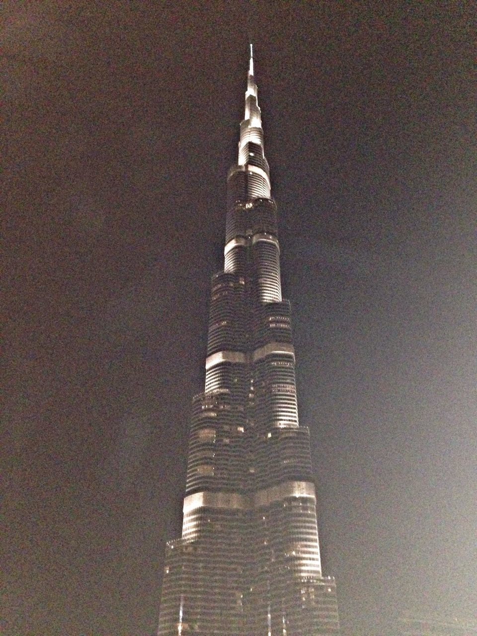 architecture, building exterior, built structure, low angle view, tower, tall - high, illuminated, clear sky, building, lighting equipment, night, modern, city, no people, copy space, outdoors, skyscraper, wall - building feature, sky