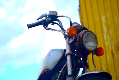 Close-up of bicycle parked against blurred background