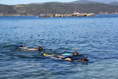 People swimming in sea
