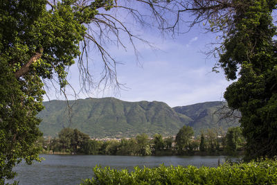 Scenic view of lake and mountains against sky