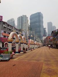 City street and buildings against sky