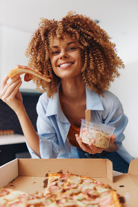 Portrait of young woman having food