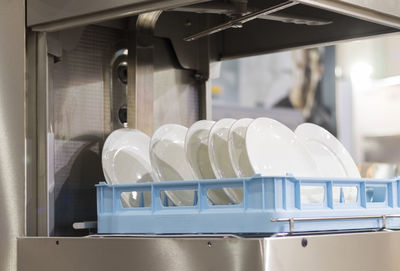 Close-up of plates in dishwasher