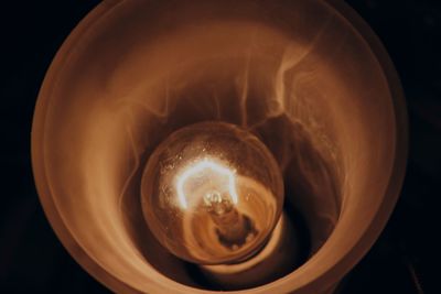 Close-up of electric lamp against black background