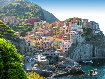 Residential buildings on cliff against sky