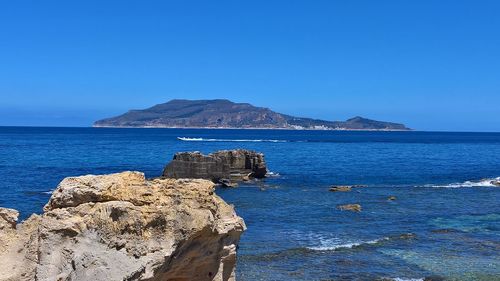 Scenic view of sea against clear blue sky