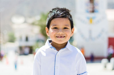 Portrait of smiling boy standing outdoors