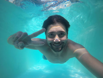 Portrait of man swimming in pool