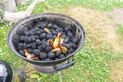 High angle view of bonfire on barbecue grill in yard