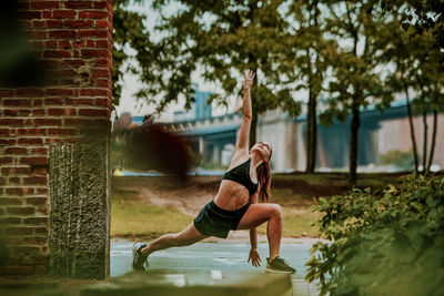 Young woman exercising outdoors in park.