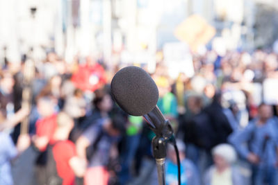 Close-up of microphone against audience