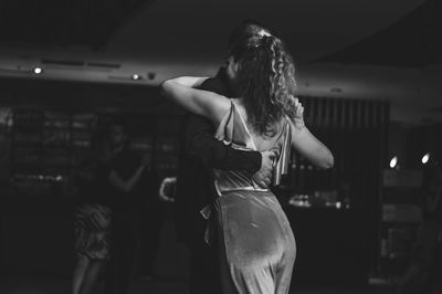 Close-up of couple dancing in darkroom