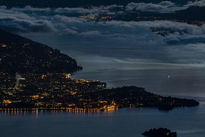 Aerial view of city by sea against sky