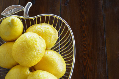 Unwaxed lemons in an apple shape chrome bowl