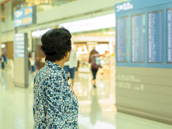 Rear view of woman walking in corridor