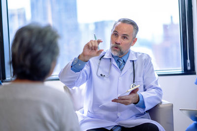 Female doctor examining patient in hospital