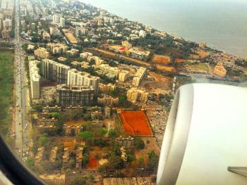 Aerial view of cityscape seen through airplane window