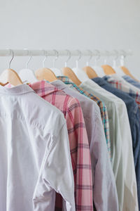 Dressing room or rail with clothes on hangers shirts and dresses. a clothing store or boutique. a