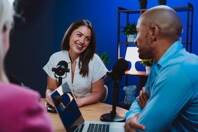Young man using mobile phone while sitting on table
