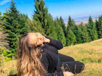 Young woman sitting on land