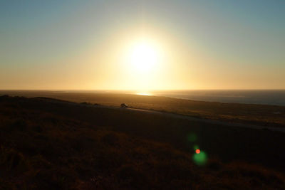 Scenic view of sea against clear sky during sunset