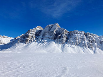 Snowcapped mountains against blue sky