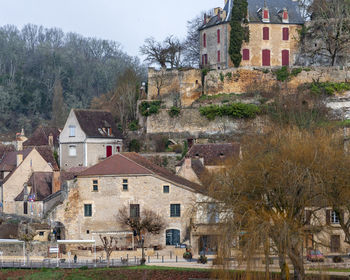 Buildings in town against sky