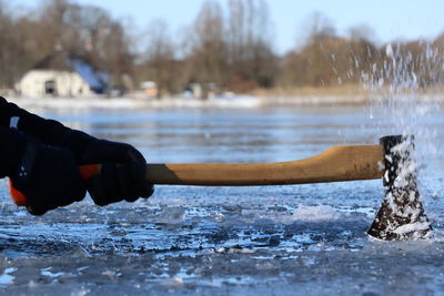 Midsection of man splashing water