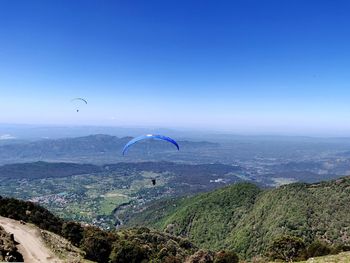 Scenic view of mountain against blue sky