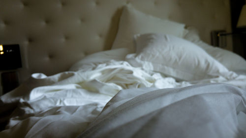 Wrinkled sheet on bed at home