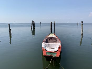 Boats moored in sea against sky