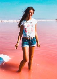 Full length of woman standing on beach