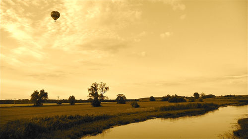 Scenic view of field against sky during sunset